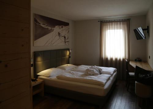 מיטה או מיטות בחדר ב-Family Hotel Gran Baita