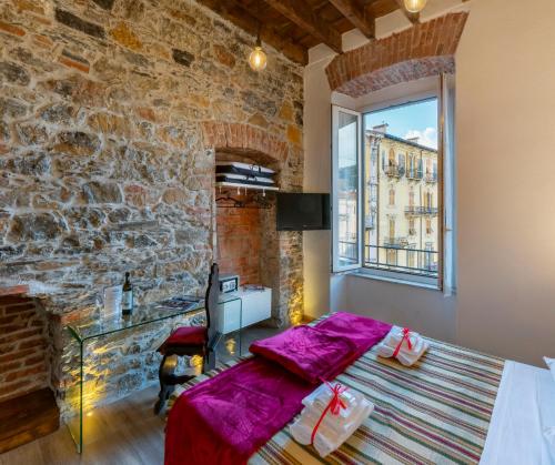 a bedroom with a bed and a stone wall at Affittacamere Superior del Golfo e delle 5 Terre in La Spezia