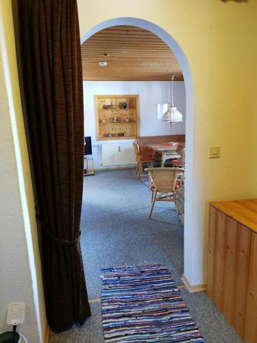 an archway in a living room with a dining room at Ferienhaus-Haidweg-Wohnung-2 in Haidmühle