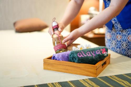 a person playing with a toy in a wooden box at Swiss-Belhotel Serpong in Serpong