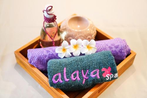 a wooden tray with aania sign and flowers on it at Swiss-Belhotel Serpong in Serpong