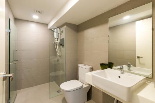 a bathroom with a toilet and a sink and a shower at EkoCheras Cozy Suite by DreamScape in Kuala Lumpur