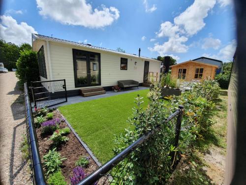 a house with a yard with a lawn at Vakantiepark Kijkduin - 711 in The Hague