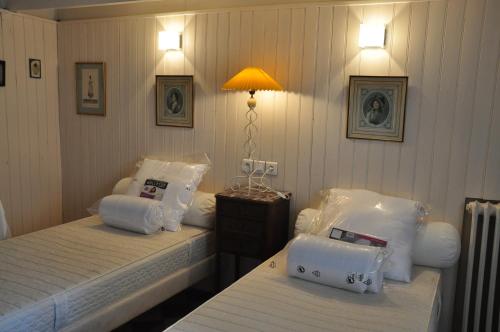 ein Hotelzimmer mit 2 Betten mit Kissen darauf in der Unterkunft Maison de famille aux Sables d'Olonne in Les Sables-dʼOlonne