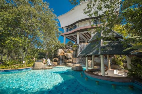 a swimming pool in front of a resort at Long Beach Garden Hotel & Pavilions in North Pattaya