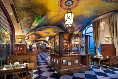 a restaurant with a painting on the ceiling of a room at Crowne Plaza Ocean Spring Resort by IHG in Jimo