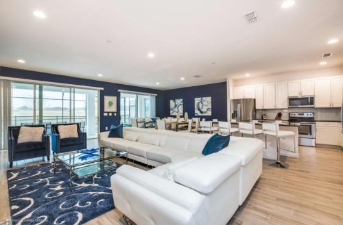 a living room with white furniture and a kitchen at Varios Resort Pool Homes in Davenport
