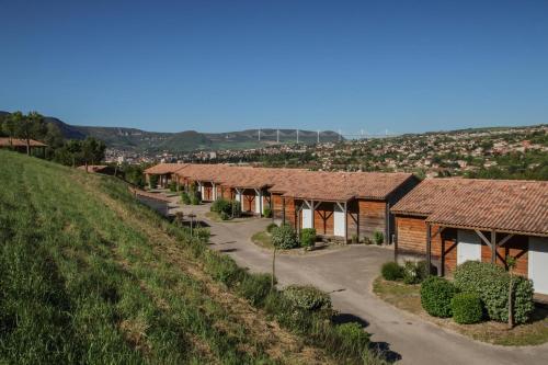 a row of cottages on the side of a hill at Domaine Saint Estève in Millau