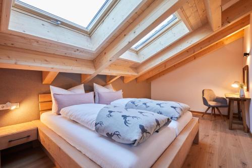 a bedroom with two beds in a loft at Landhaus Herzogsteig in Krün