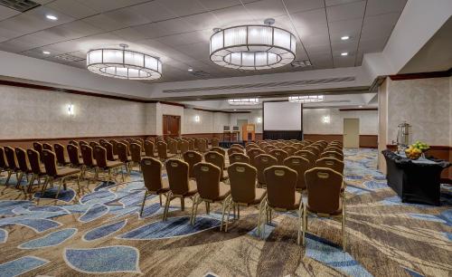 a conference room with rows of chairs and a podium at Crowne Plaza Crystal City-Washington, D.C. by IHG in Arlington