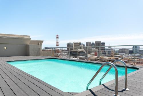 a swimming pool on the roof of a building at Four Seasons Apartments in Cape Town