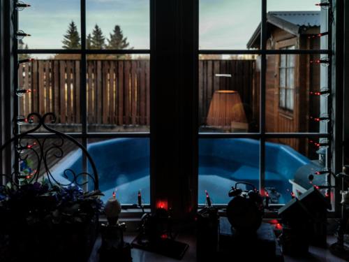 a view of a swimming pool through a window at Nupan Deluxe in Keflavík