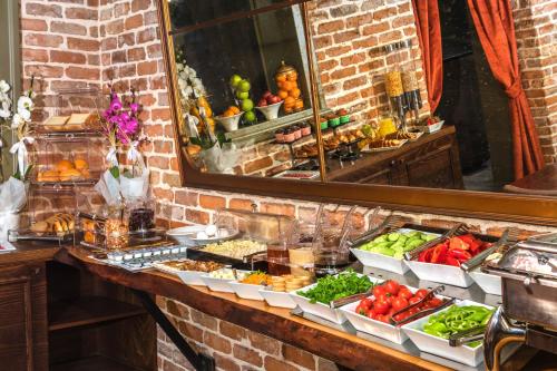 a buffet of fruits and vegetables on a counter at Meroddi Galata Mansion in Istanbul