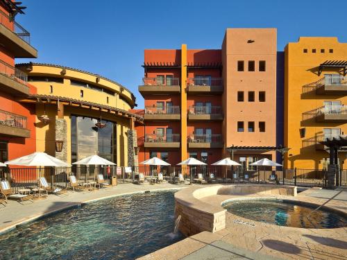 a hotel with a swimming pool in front of buildings at Desert Diamond Casino in Tucson