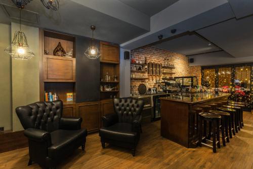 a bar with leather chairs and a bar counter at Meroddi Galata Mansion in Istanbul