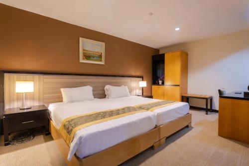 a large bedroom with a large bed in it at Hallmark View Hotel in Melaka