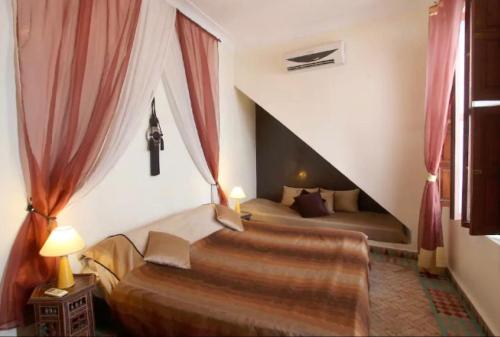 Postel nebo postele na pokoji v ubytování Riad Al Warda