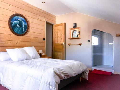 a bedroom with a large bed and a wooden wall at Boost Your Immo Les Deux Alpes 185 in Les Deux Alpes