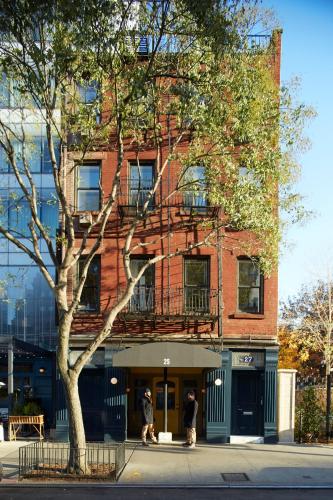 two people walking in front of a brick building at The Standard - East Village in New York