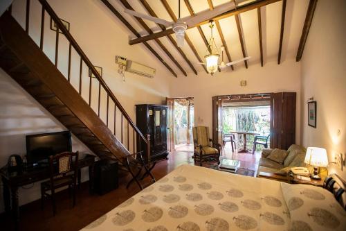 a bedroom with a bed and a staircase in a room at Presa di Goa - Managed by Smith and Appy in Calangute