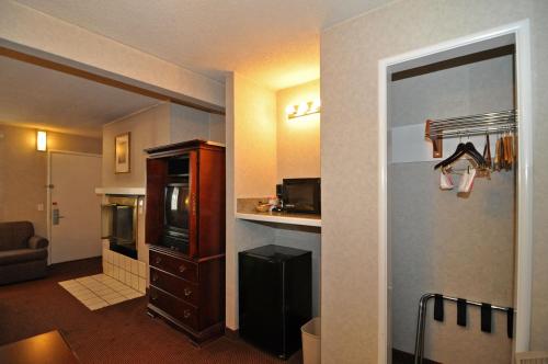a hotel room with a kitchen and a living room at Pelican Inn in Monterey