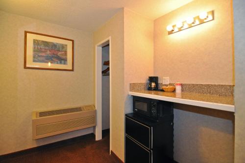 a hotel room with a kitchen with a counter top at Pelican Inn in Monterey