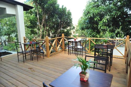 a group of tables and chairs on a wooden deck at G y V Hotels in Tegucigalpa