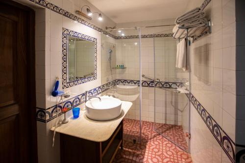 a bathroom with a sink and a mirror at Presa di Goa - Managed by Smith and Appy in Calangute
