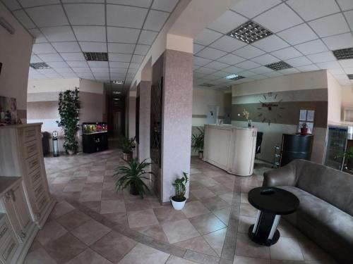 a lobby with a couch and a table in a building at Hotel Resttime in Kovelʼ