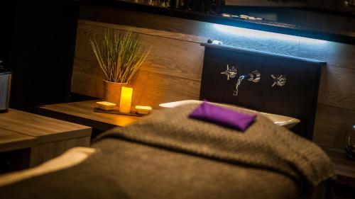a bed with a purple pillow in a room at Heywood Spa Hotel in Tenby