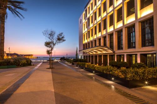 a building with a sidewalk in front of a building at Key Hotel in Izmir