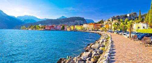 a row of cars parked next to a body of water at CROSINA HOLIDAY - Casa Lucia in Ledro