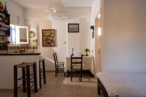 a room with a table and chairs and a kitchen at Margarita Apartments in Ierápetra