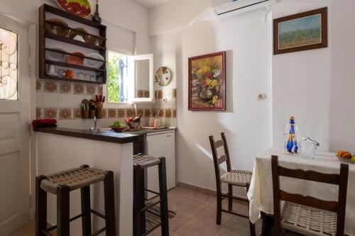 a kitchen with a table and chairs in a room at Margarita Apartments in Ierápetra