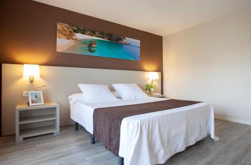 a hotel room with a bed and a television at Helios Benidorm in Benidorm