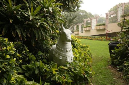 a statue of a bird in a garden at Taj Palace, New Delhi in New Delhi
