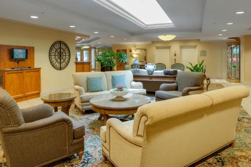a living room filled with furniture and a tv at The Mediterranean Inn in Seattle