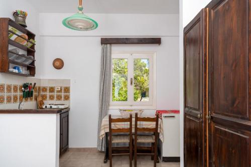 a kitchen with a table and chairs and a window at Margarita Apartments in Ierápetra