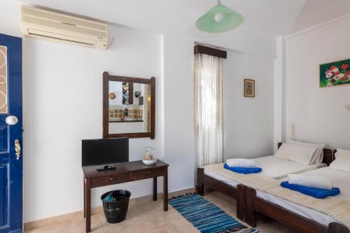 a living room with a bed and a table at Margarita Apartments in Ierápetra