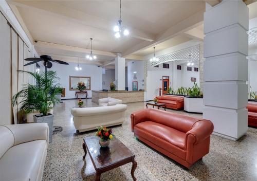 a living room filled with furniture and a large window at Hotel Dorado Plaza Centro Histórico in Cartagena de Indias