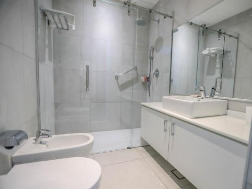 
a bathroom with a sink, toilet and mirror at La Locanda Boutique Hotel in Amman
