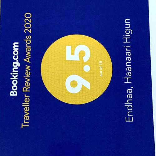 a yellow circle with an equals sign on a blue book at Endhaa, Divers Home in Fuvahmulah