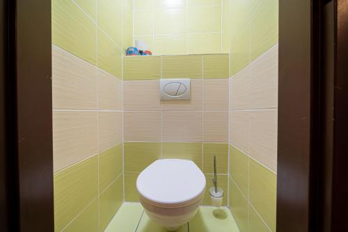 a bathroom with a white toilet in a room at Rodinný penzión Rogalo in Mengusovce
