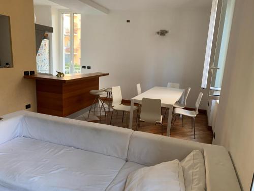 a living room with a white couch and a table at Casa Arturo in Finale Ligure
