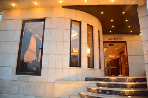a building with stairs in front of a store at سما عمان للشقق الفندقية Sama Amman Hotel Apartments in Amman
