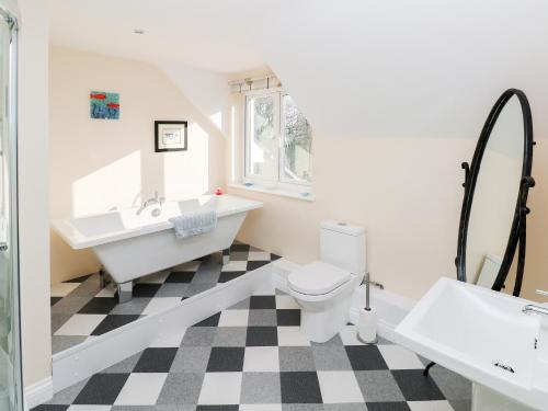 a bathroom with a black and white checkered floor at The Laurels in Haverfordwest