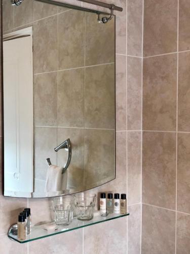 a bathroom with a mirror and a sink at Hardwick Arms Hotel in Sedgefield