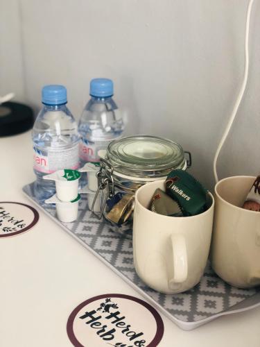 a shelf with bottles of water and a measuring cup at Hardwick Arms Hotel in Sedgefield