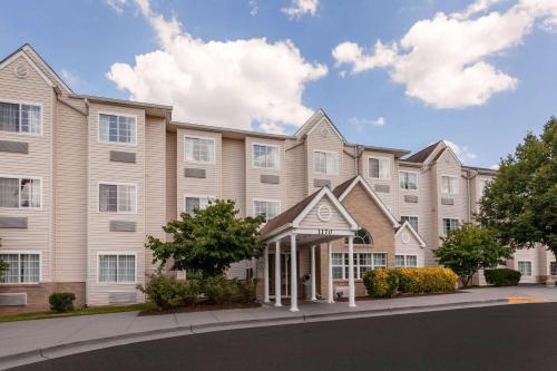 a large apartment building with a street in front of it at Microtel Inn Suite by Wyndham BWI Airport in Linthicum Heights