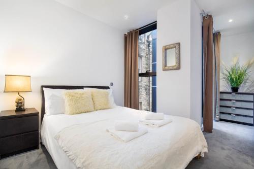 A bed or beds in a room at Quartermile Central Apartment